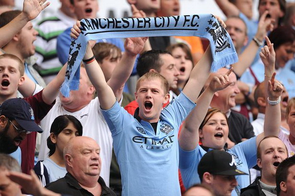 A Manchester City fan shows his support in the stands during the FA Community Shield at Villa Park
