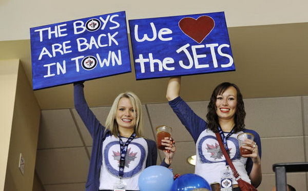 Winnipeg Jets fans cheer as their team plays the Montreal Canadiens during the first period of their NHL hockey game in Winnipeg
