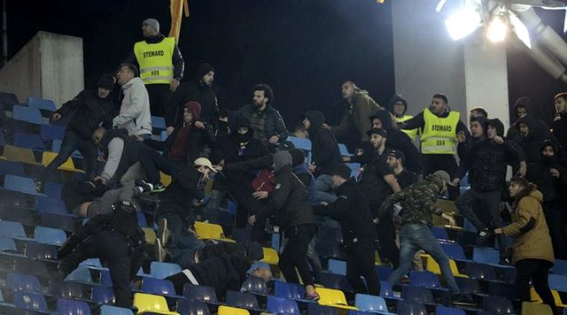 Supporters clash during the World Cup Group E, qualifying soccer match between Romania and Poland on the National Arena stadium, in Bucharest, Romania, Friday, Nov. 11, 2016. (AP Photo/Alexandru Dobre)